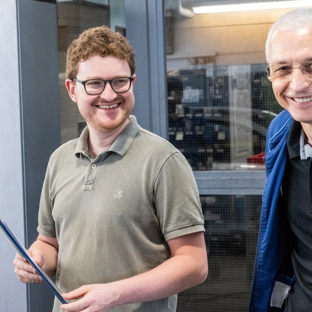 Zwei Mitarbeiter von Autohaus Biggel stehen in der Werkstatt